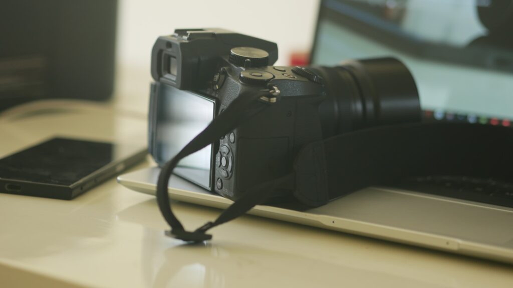 a camera sitting on top of a laptop computer