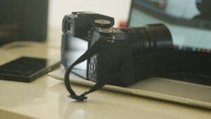 a camera sitting on top of a laptop computer