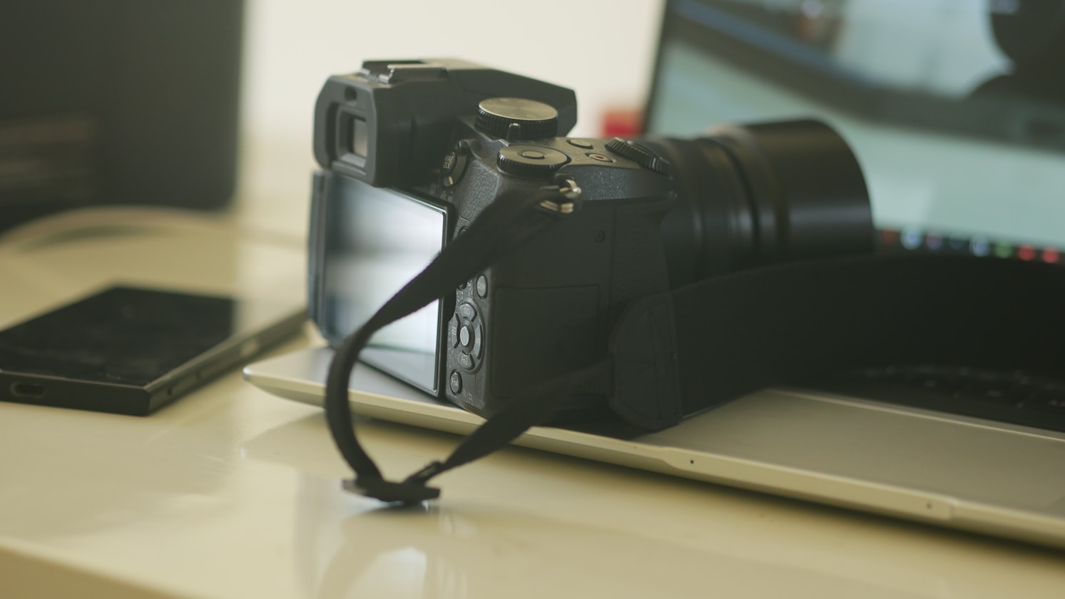 a camera sitting on top of a laptop computer